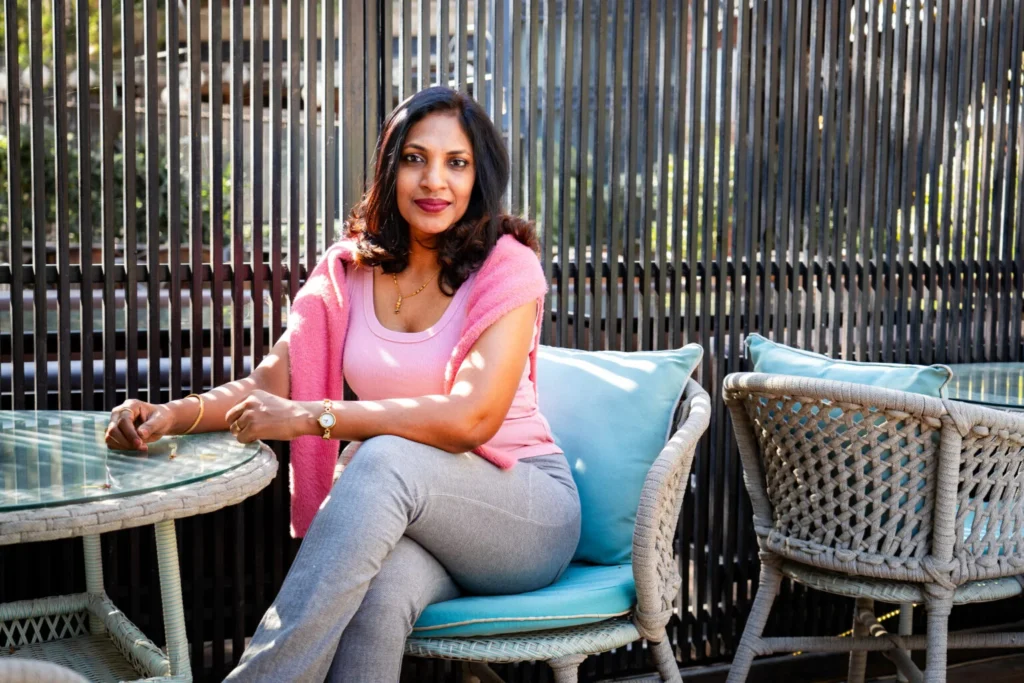 woman sitting cross legged in chair wearing cool casual wear