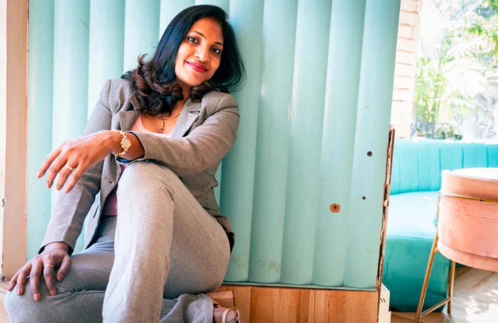 Power poses against wall for female professionals