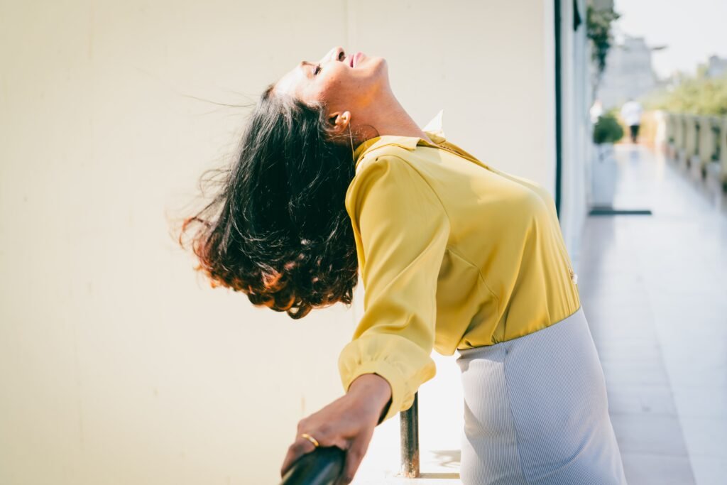 semi formal suit pose of professional woman leaning on railing skyward